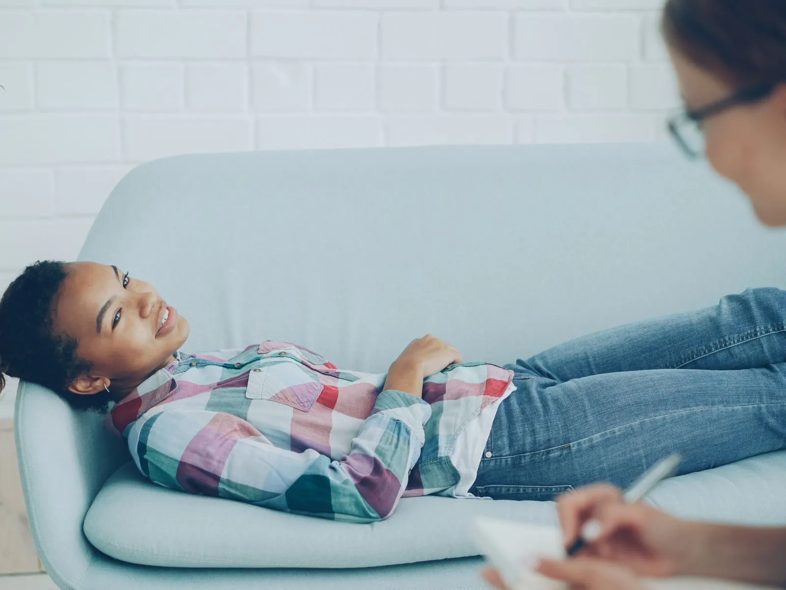 A person in an individual counselling session with a counsellor, both smiling naturally