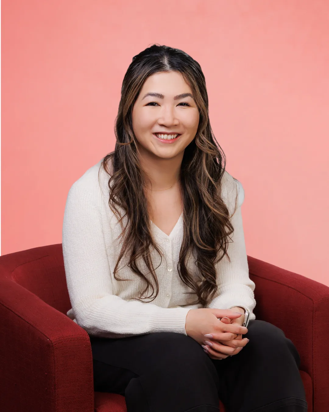 Duy Nyguen sitting in a red armchair