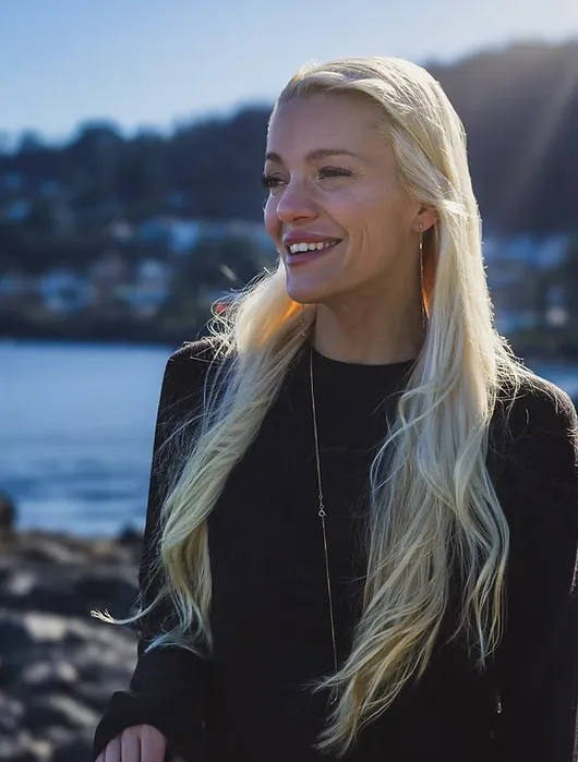 Jessica Mckay smiling beside the water