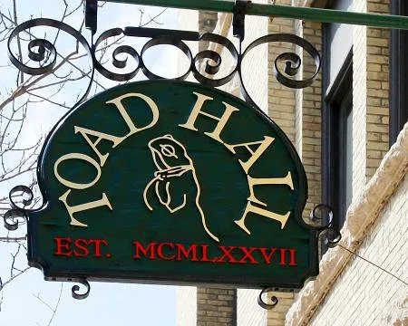 Toad Hall Toys green circular logo with a dog silhouette